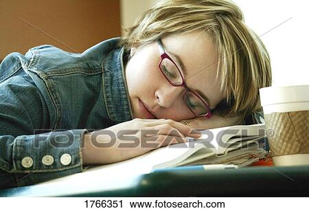 Stock Image - Student falls asleep on book. Fotosearch