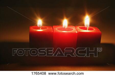 Stock Photo - Three red candles. Fotosearch