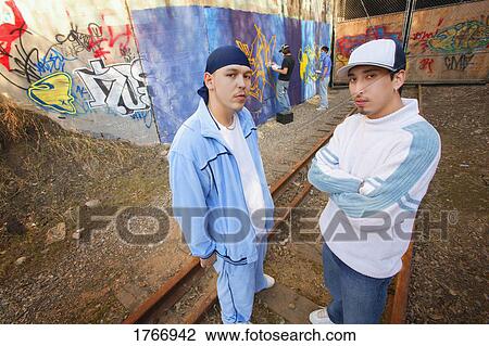 Two men by graffiti View Large Photo Image Stock Image - Two men by graffiti. Fotosearch