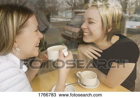 Stock Image - Two women in a cafe. Fotosearch