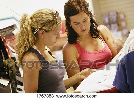 Stock Image - Two women shopping. Fotosearch