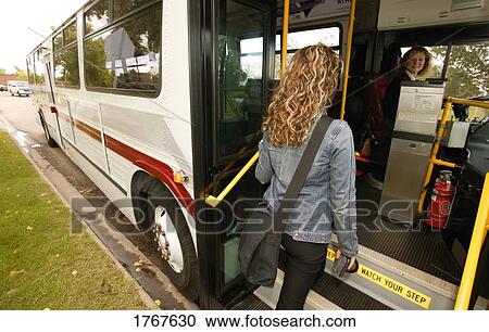 Woman enters a public bus View Large Photo Image Stock Image - Woman enters a public bus. Fotosearch