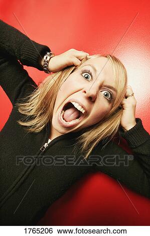 Stock Photograph - Woman pulls her hair out. Fotosearch