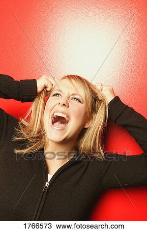 Stock Image - Woman screams in anger. Fotosearch