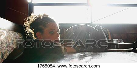 Picture - Woman sits alone. Fotosearch