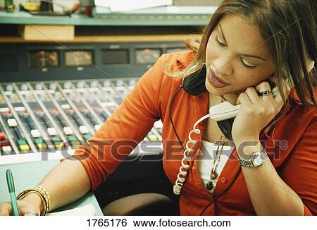 Stock Photograph - Woman talks on the phone. Fotosearch