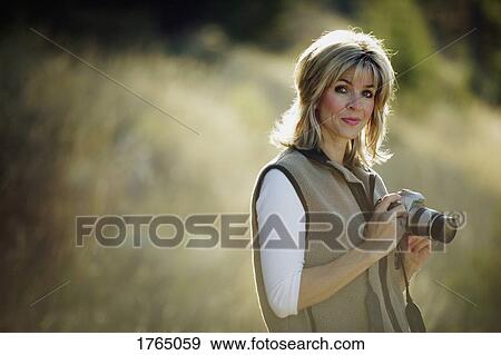 Woman with camera View Large Photo Image Stock Photo - Woman with camera. Fotosearch