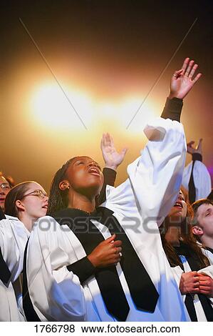 Stock Photo - Worshipping in a choir. Fotosearch