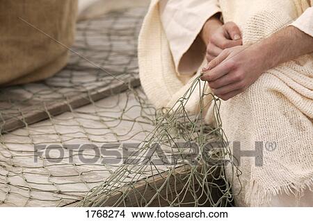 A fisherman working on net View Large Photo Image Picture - A fisherman working on net. Fotosearch