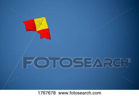 A kite flies in the sky View Large Photo Image Stock Photo - A kite flies in the sky. Fotosearch