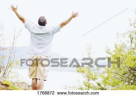 A man lifts his hands towards heaven View Large Photo Image Stock Image - A man lifts his hands towards heaven. Fotosearch