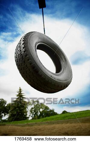 A tire swing in a playground View Large Photo Image Stock Photo - A tire swing in a playground. Fotosearch