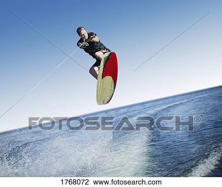 A wake boarder jumps View Large Photo Image Stock Image - A wake boarder jumps. Fotosearch