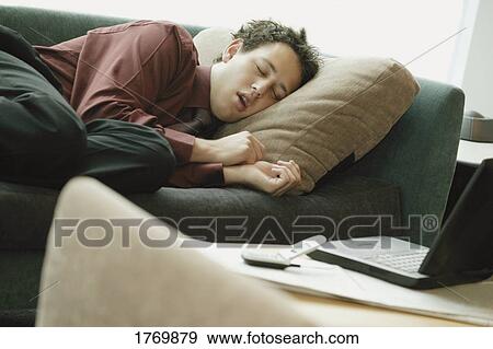 Asleep on the sofa View Large Photo Image Stock Photo - Asleep on the sofa. Fotosearch