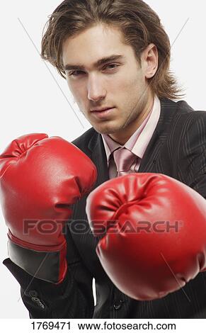 Stock Image - Businessman with boxing gloves. Fotosearch