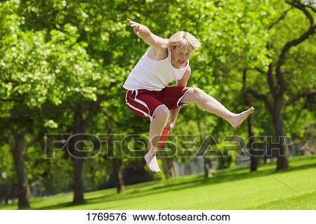 Stock Photograph - Catching Frisbee in the air. Fotosearch