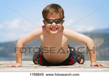 Child does a pushup View Large Photo Image Stock Photo - Child does a pushup. Fotosearch