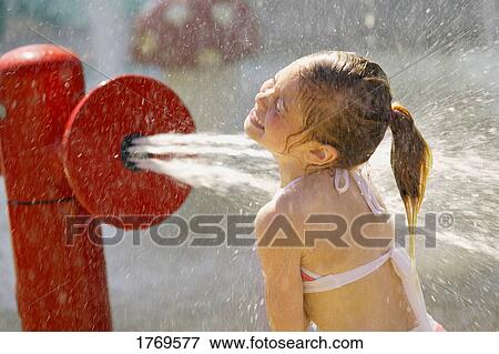 Child getting sprayed with water View Large Photo Image Stock Photo - Child getting sprayed with water. Fotosearch
