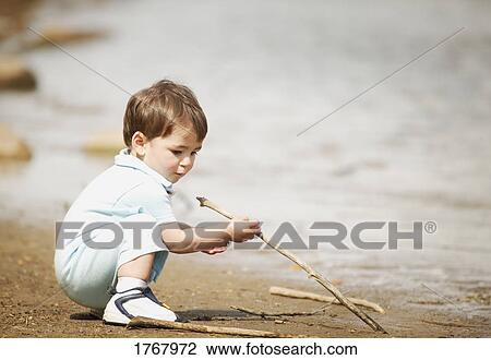 Child plays with sticks View Large Photo Image Stock Image - Child plays with sticks. Fotosearch