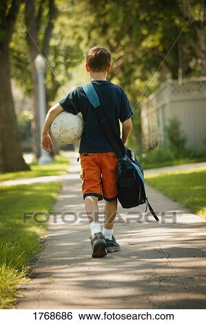 Child walks home from school View Large Photo Image Stock Photograph - Child walks home from school. Fotosearch