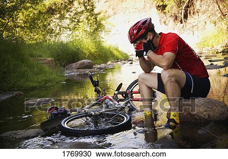 Stock Image - Cyclist in a bind. Fotosearch