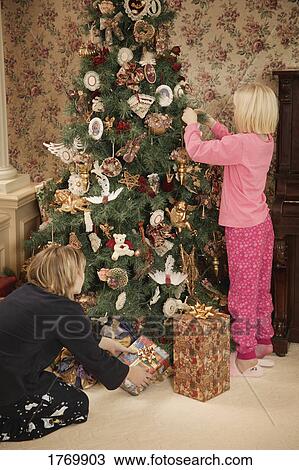 Decorating the Christmas tree View Large Photo Image Stock Image - Decorating the Christmas tree. Fotosearch
