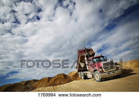 Dump truck unloading View Large Photo Image Picture - Dump truck unloading. Fotosearch