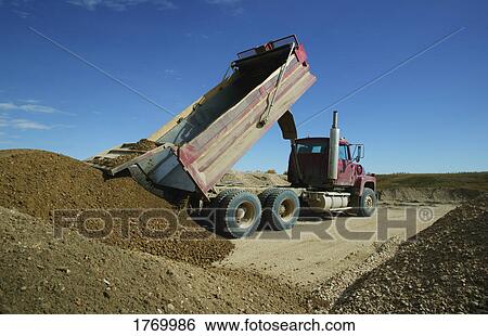 Dump truck unloading View Large Photo Image Stock Photograph - Dump truck unloading. Fotosearch