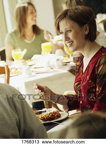 Eating brunch in a restaurant View Large Photo Image Stock Image - Eating brunch in a restaurant. Fotosearch