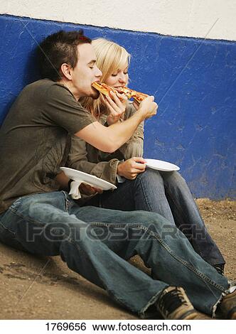 Stock Photograph - Eating pizza. Fotosearch