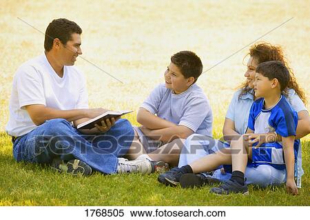 Family listens as father reads a book View Large Photo Image Stock Photography - Family listens as father reads a book. Fotosearch
