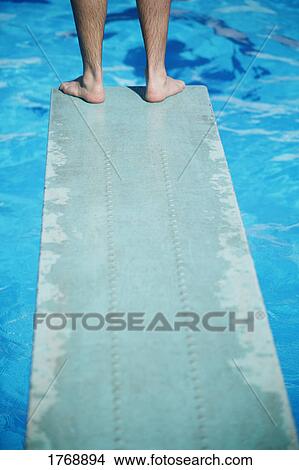 Feet on the edge of a diving board View Large Photo Image Picture - Feet on the edge of a diving board. Fotosearch