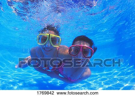 Stock Image - Females with goggles in swimming pool. Fotosearch