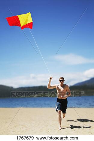 Flying a kite View Large Photo Image Stock Photo - Flying a kite. Fotosearch