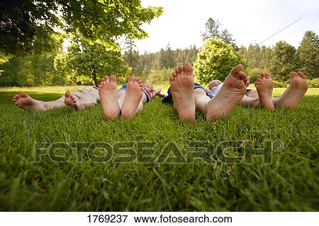 Four pairs of small feet View Large Photo Image Stock Photo - Four pairs of small feet. Fotosearch