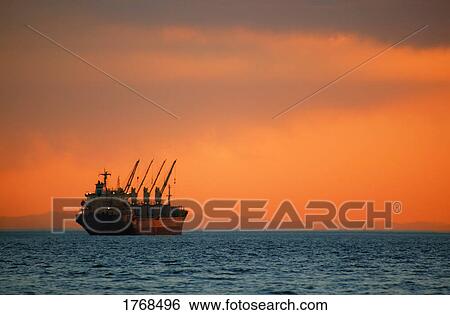 Stock Photograph - Freighter on ocean. Fotosearch
