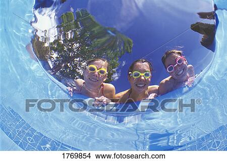 Picture - Friends peering into a pool. Fotosearch