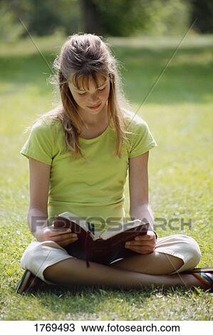 Girl reads a book View Large Photo Image Stock Image - Girl reads a book. Fotosearch