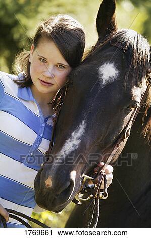 Stock Image - Girl with her horse. Fotosearch