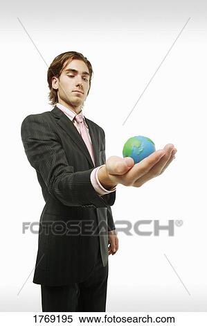 Stock Photography - Holding the world in his hand. Fotosearch