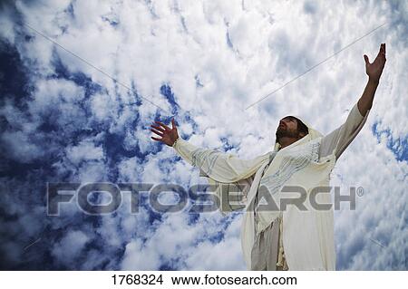 Picture - Jesus lifts his hands towards heaven. Fotosearch