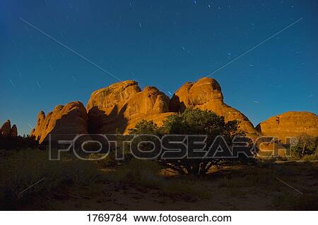 Picture - Large rock formation at dusk. Fotosearch