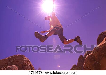 male/man/teenager leaping on rocks View Large Photo Image Stock Photo - male/man/teenager leaping on rocks. Fotosearch