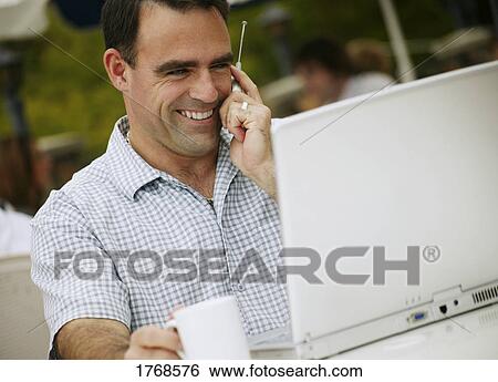 Man talks on cell phone View Large Photo Image Stock Photograph - Man talks on cell phone. Fotosearch