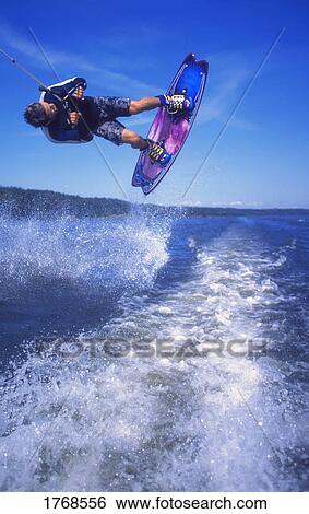 Man wakeboarding on Coal Lake Alberta Canada View Large Photo Image Stock Photograph - Man wakeboarding on Coal Lake Alberta Canada. Fotosearch