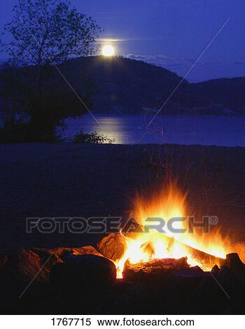 Moon rising by a bonfire View Large Photo Image Stock Photography - Moon rising by a bonfire. Fotosearch