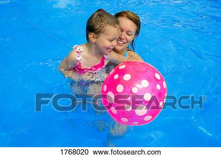 Mother and daughter in swimming pool View Large Photo Image Stock Image - Mother and daughter in swimming pool. Fotosearch