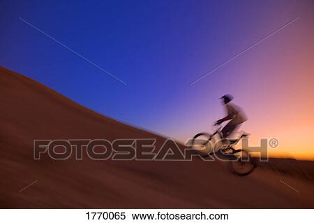 Stock Photography - Person on bike uphill. Fotosearch