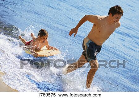 Playing in water View Large Photo Image Stock Photography - Playing in water. Fotosearch
