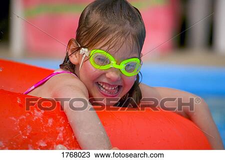 Portrait of little girl playing in swimming pool View Large Photo Image Stock Image - Portrait of little girl playing in swimming pool. Fotosearch
